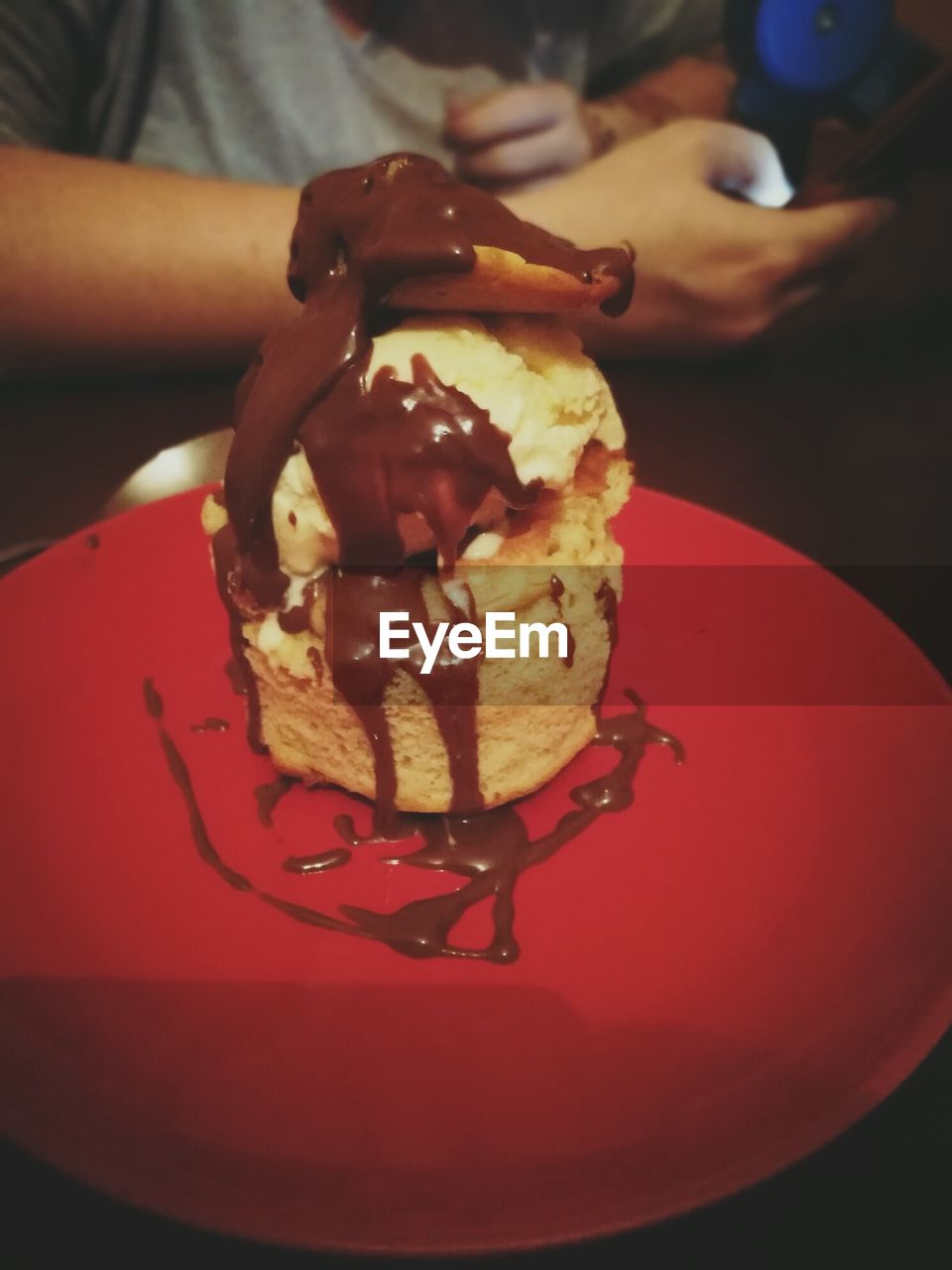 CLOSE-UP OF ICE CREAM CONE ON TABLE