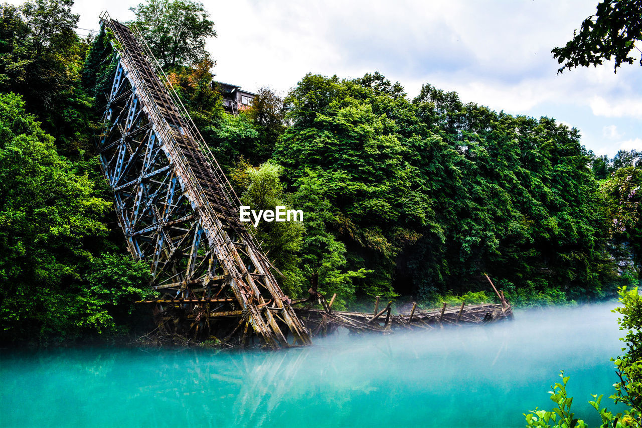 Scenic view of river against cloudy sky