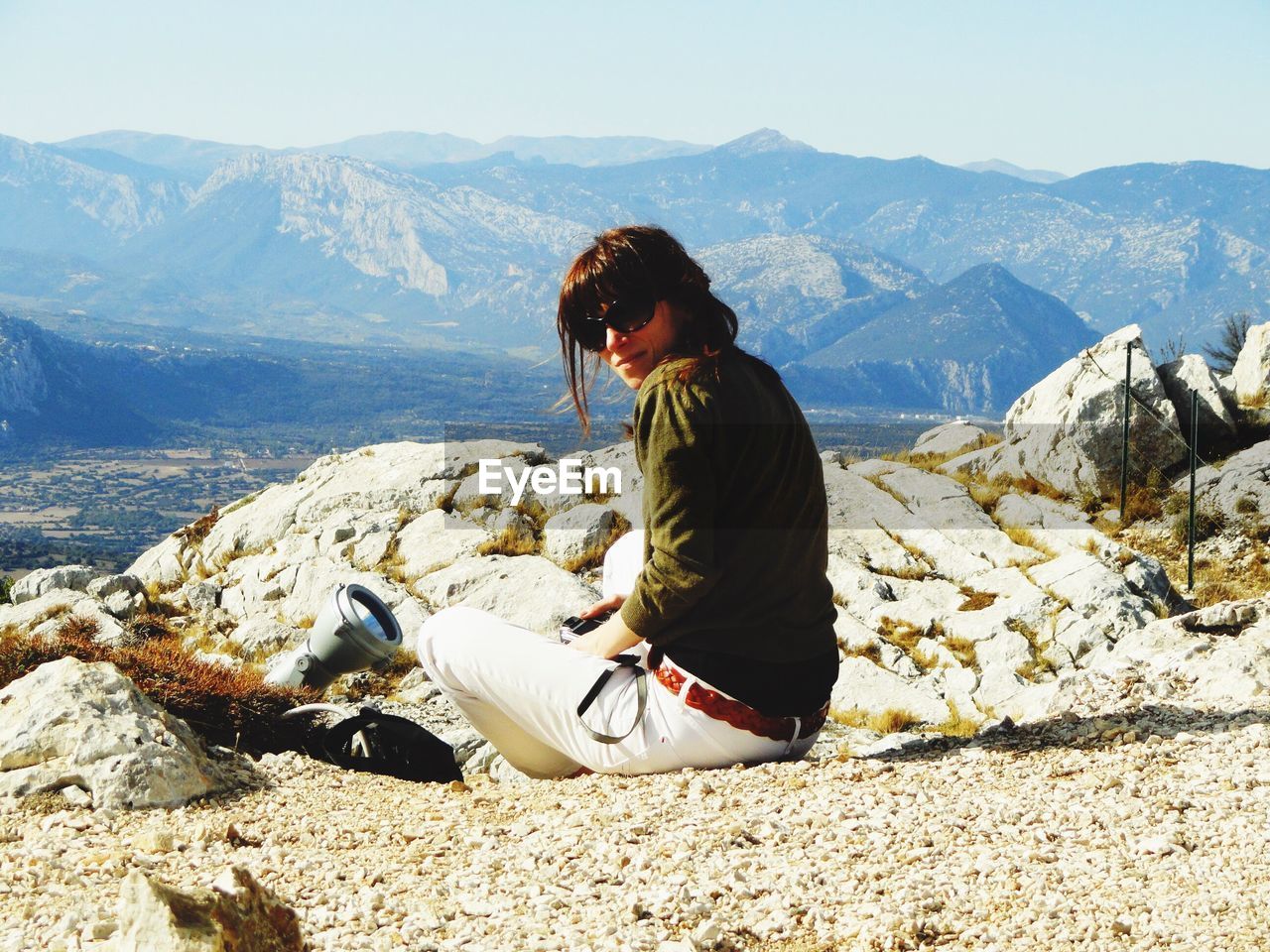 Woman sitting on mountain