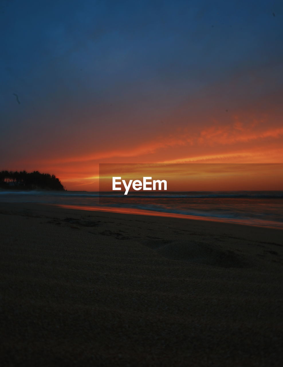 SCENIC VIEW OF BEACH DURING SUNSET