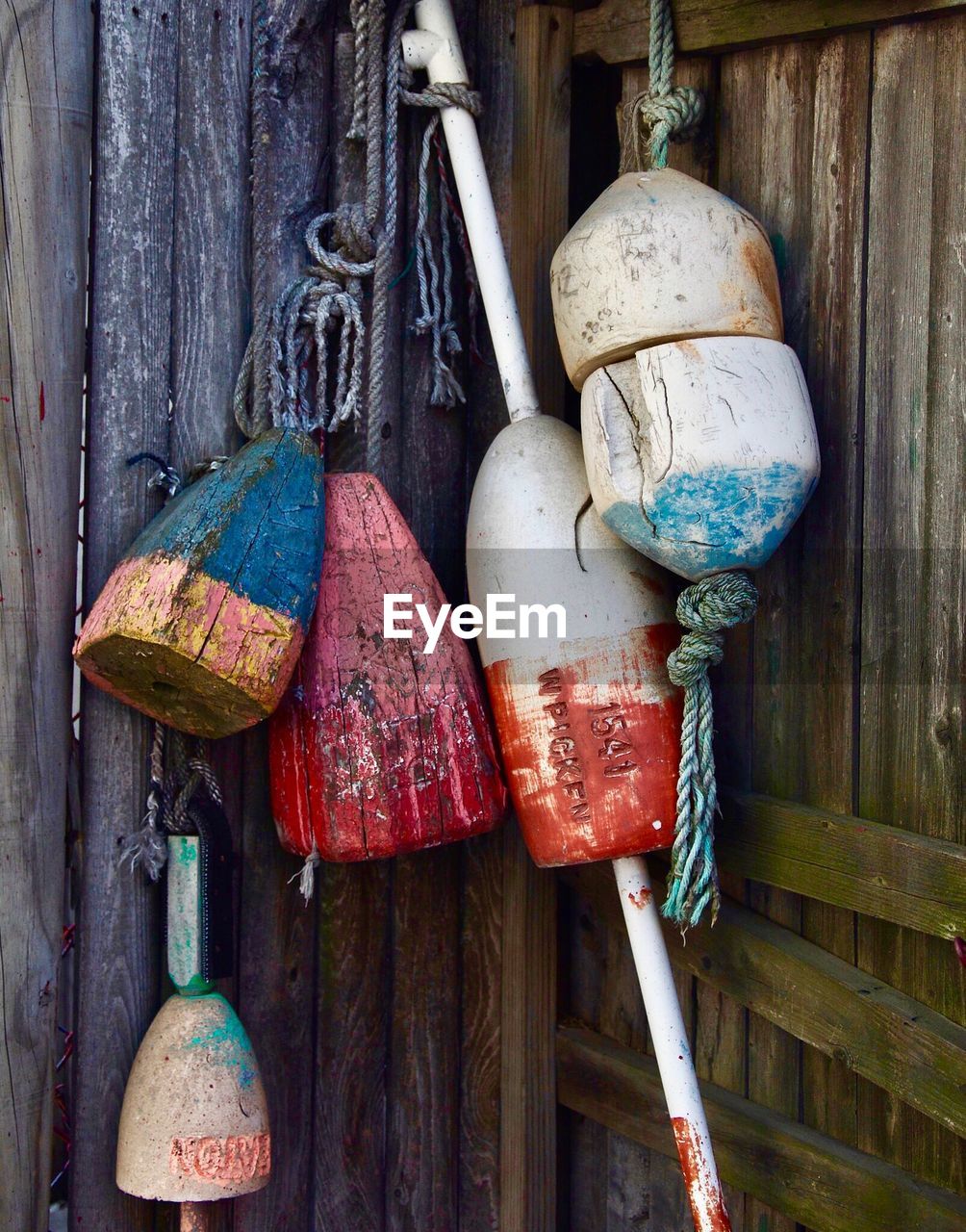 Close-up of buoy hanging against wood