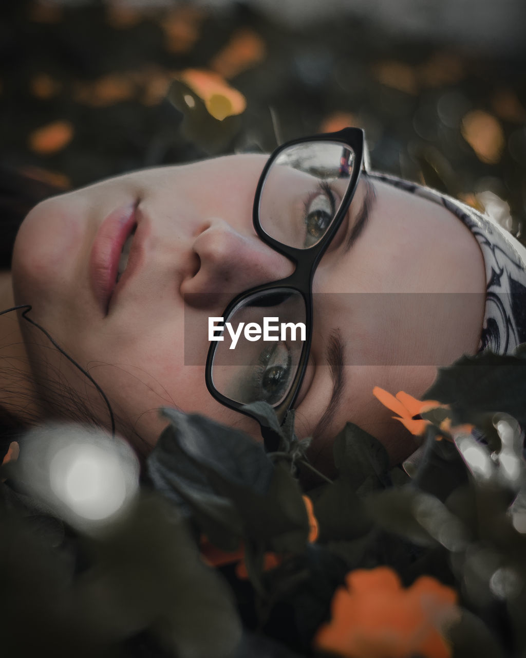 Close-up portrait of young woman wearing eyeglasses