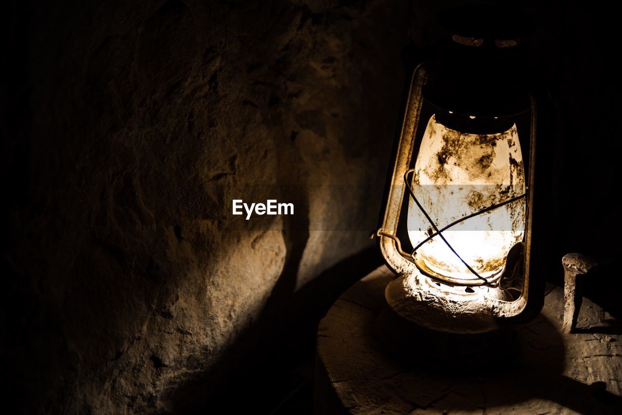 High angle view of illuminated lamp on wall in a cave