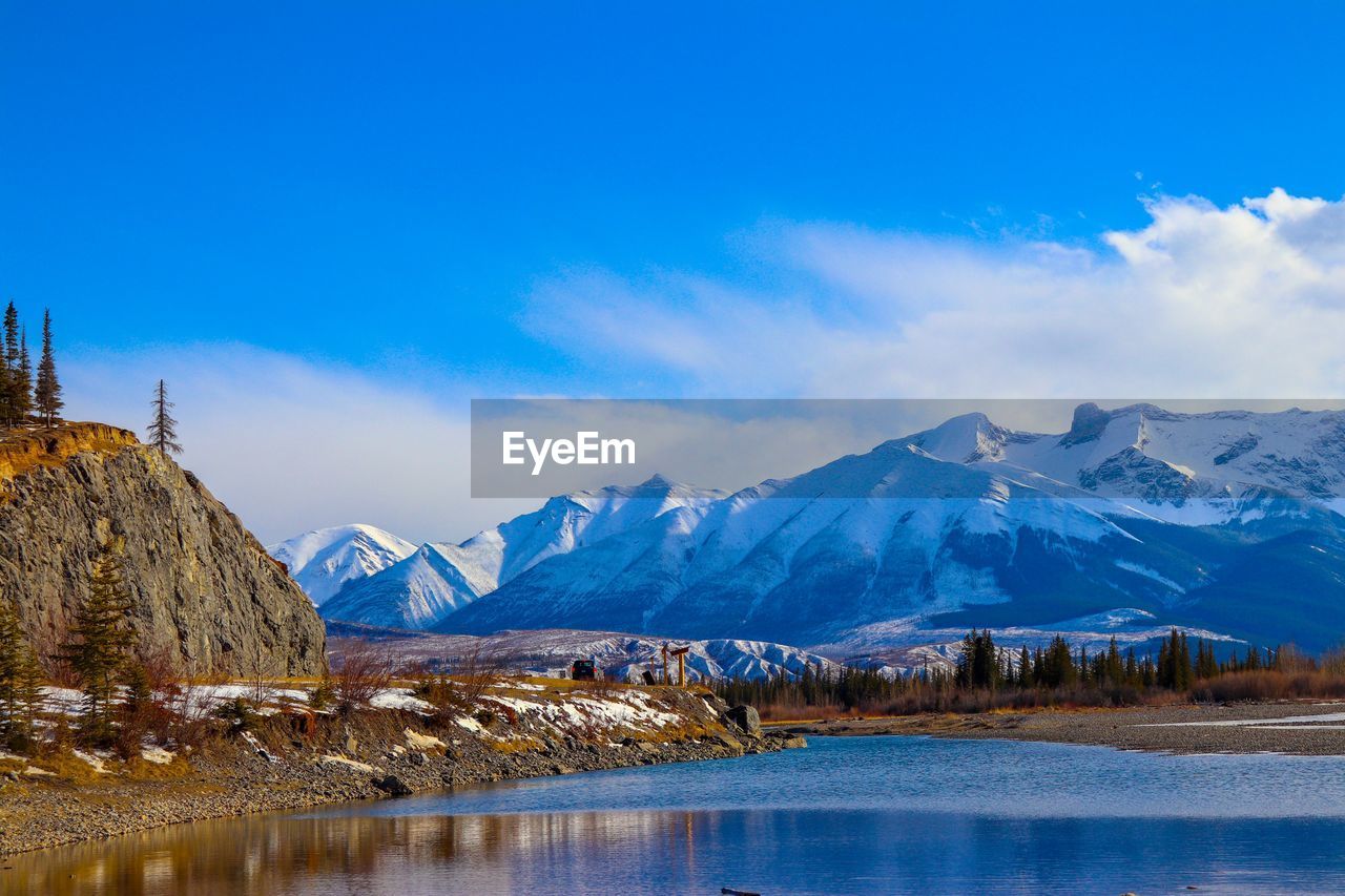 Scenic view of snowcapped mountains against sky during winter