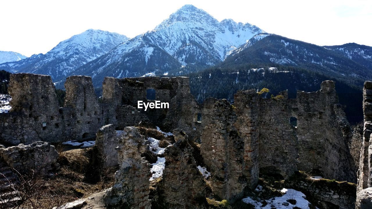 View of old ruin against mountains against sky