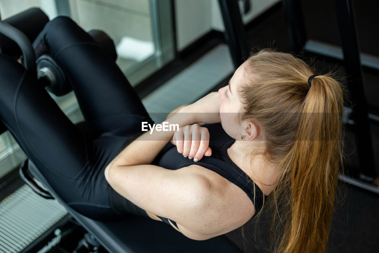 High angle view of woman exercising at gym