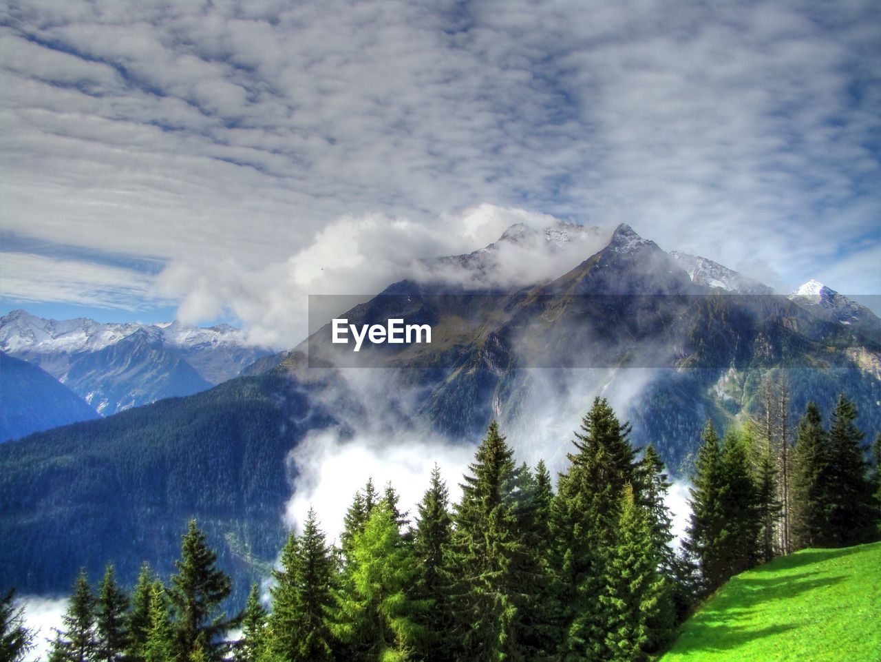 Scenic view of mountains against cloudy sky