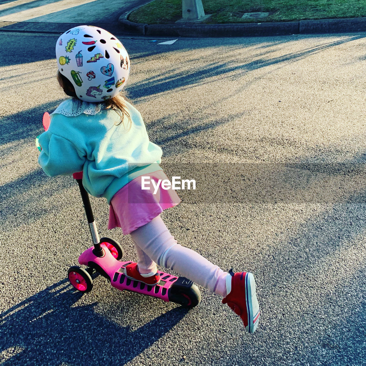 Cute girl riding bicycle on road
