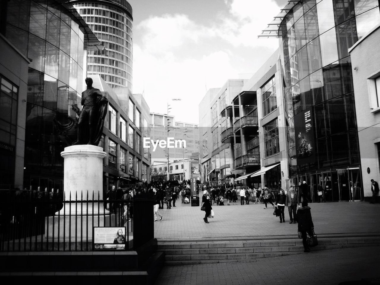 People on street amidst city buildings