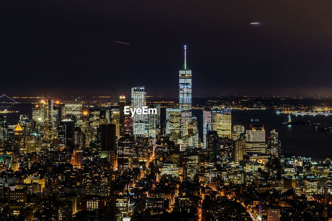 Illuminated cityscape against sky at night