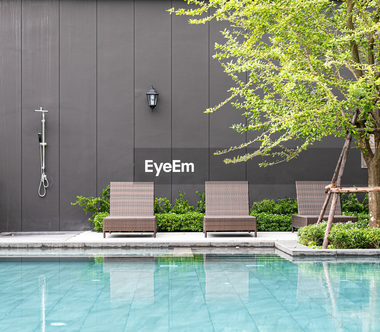 swimming pool, plant, nature, architecture, backyard, water, tree, luxury, wealth, building, built structure, relaxation, no people, building exterior, estate, outdoors, house, summer, lifestyles, tranquility, day, poolside, home, residential district, entrance, furniture, front or back yard, door, holiday, wood