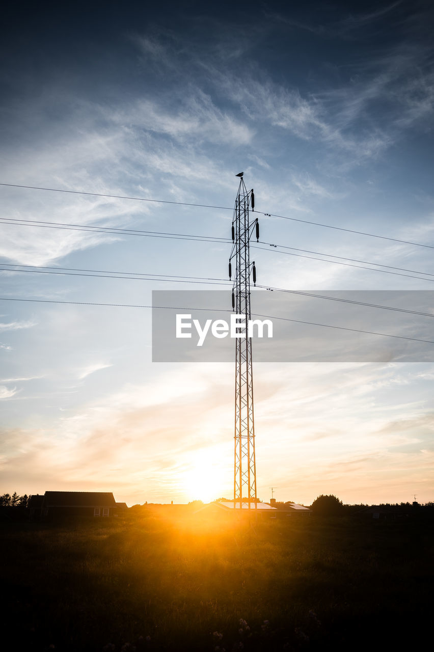 sky, technology, cloud, sunset, electricity, cable, nature, horizon, light, sunlight, power generation, silhouette, power supply, electricity pylon, no people, landscape, environment, architecture, power line, dusk, tower, built structure, sun, scenics - nature, outdoors, communication, low angle view, industry, beauty in nature, back lit, evening, land, afterglow, transmission tower, wireless technology, field, communications tower, dramatic sky, broadcasting, business finance and industry, global communications