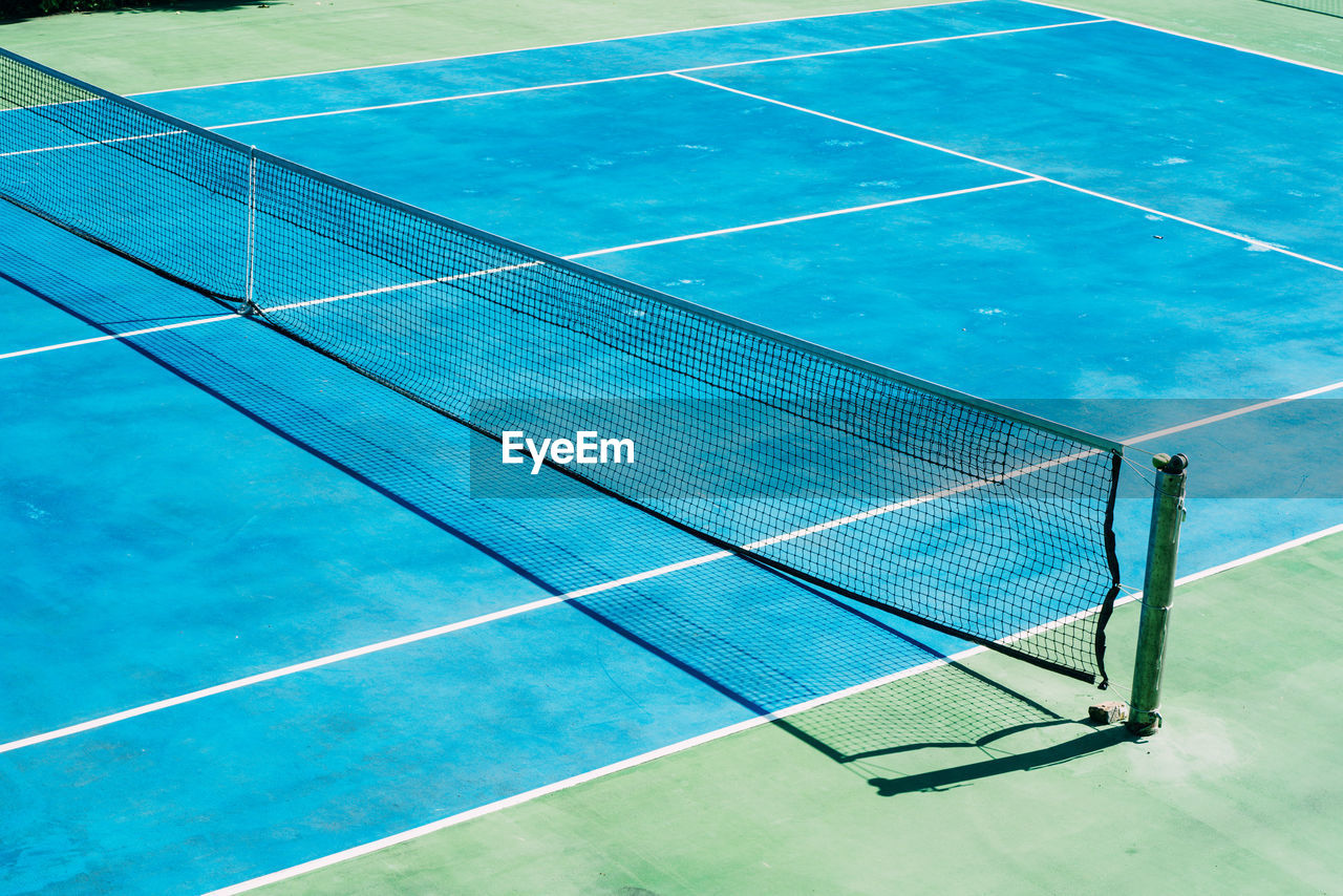 net, floor, sports, day, flooring, blue, no people, nature, swimming pool, high angle view, outdoors, absence, sunlight, tennis, empty, net - sports equipment, sport venue, environment, leisure centre, solar panel, solar energy