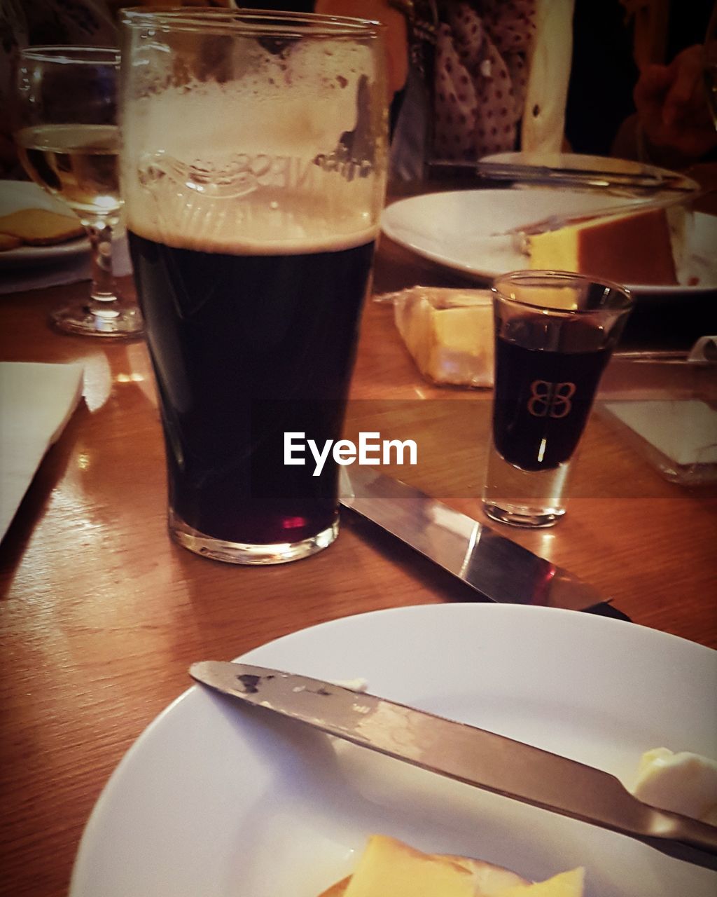 CLOSE-UP OF BEER GLASS ON TABLE IN RESTAURANT