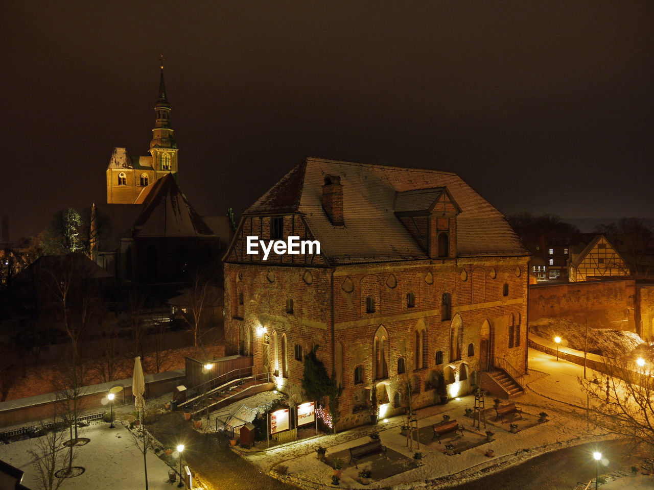 ILLUMINATED BUILDINGS AGAINST SKY AT NIGHT