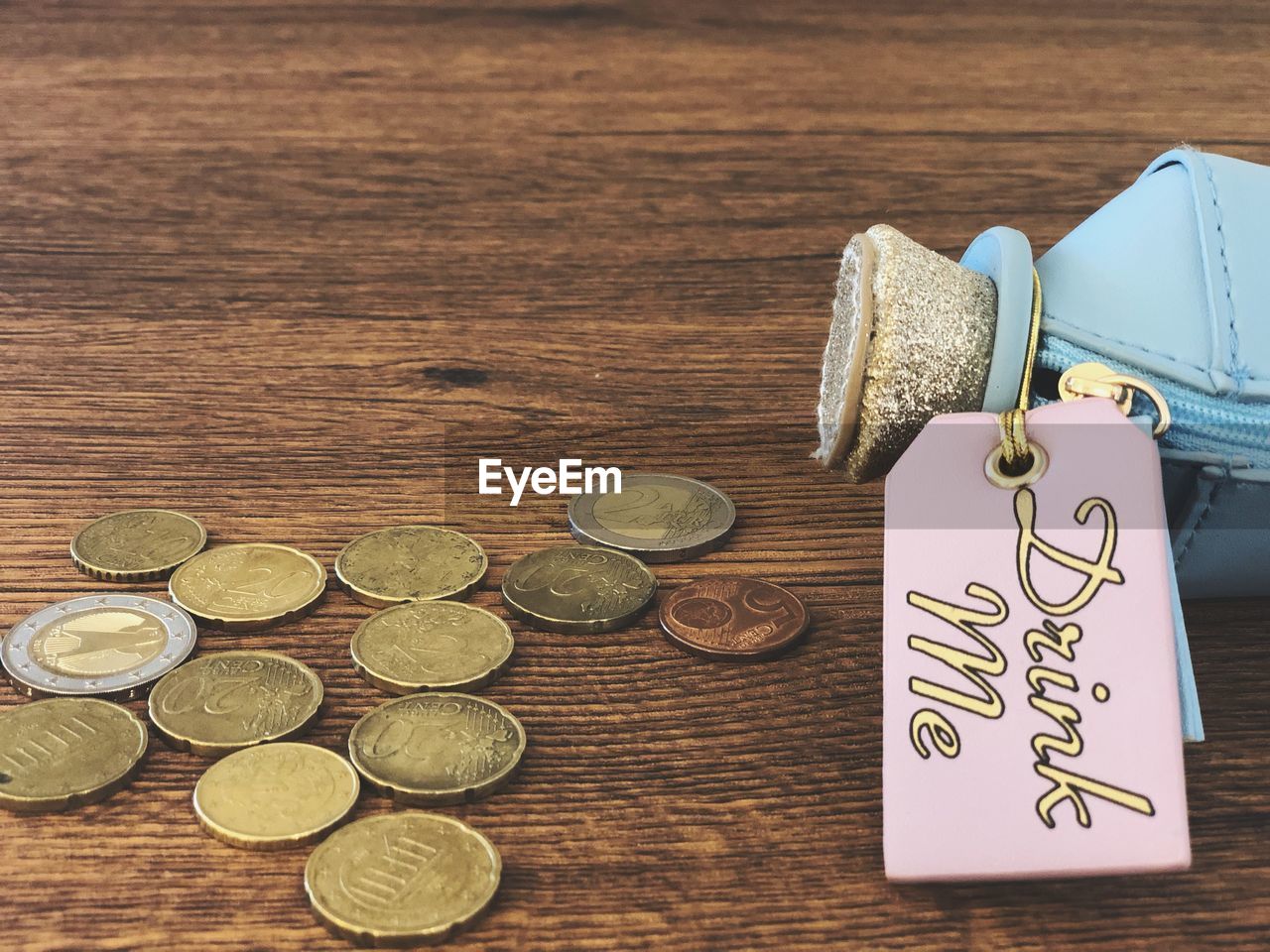 High angle view of coins with container on table