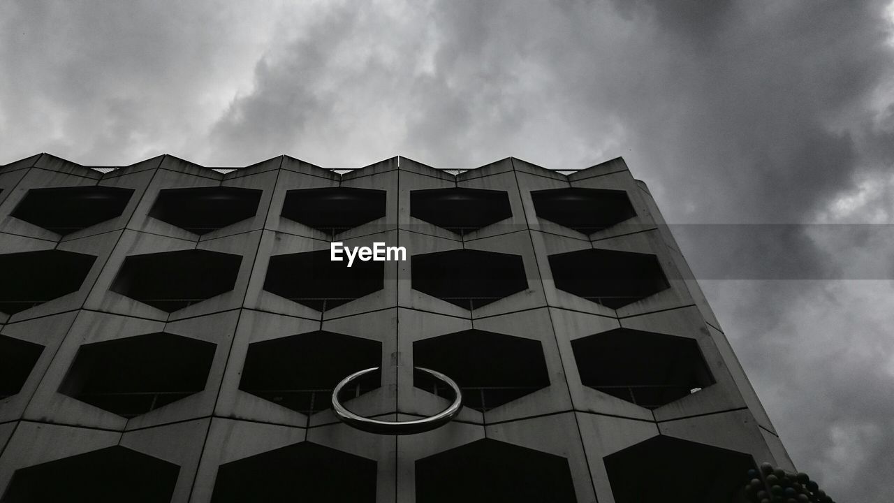 Low angle view of building against cloudy sky