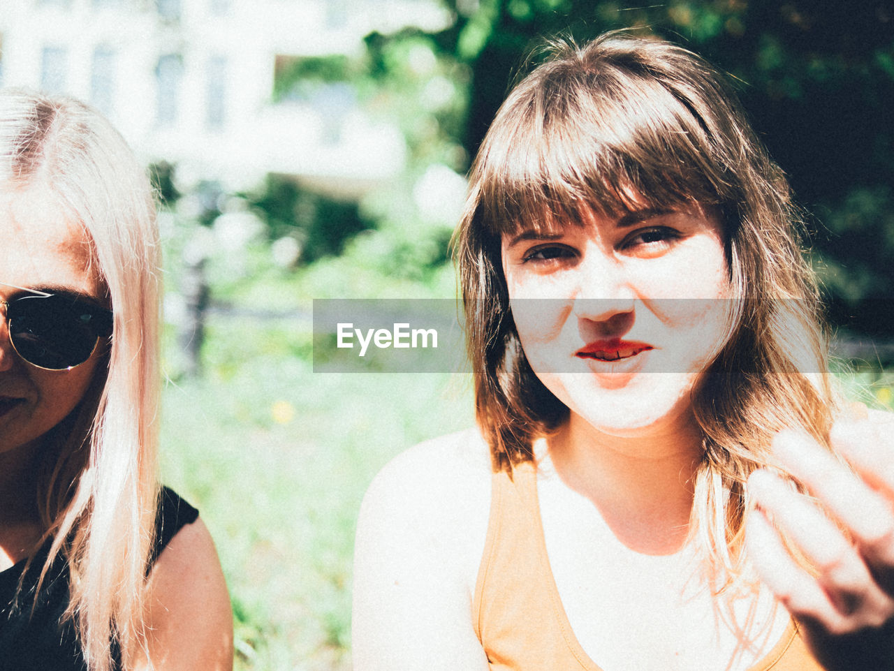 Portrait of smiling young woman with friend