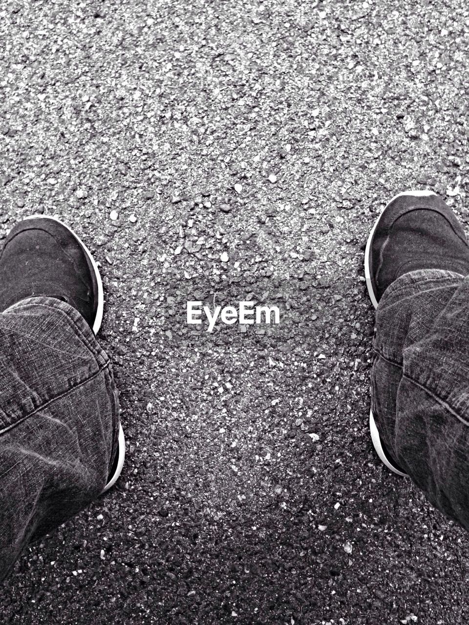 LOW SECTION OF PERSON STANDING ON ROAD