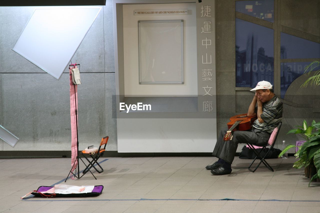 FULL LENGTH OF YOUNG WOMAN STANDING ON BENCH