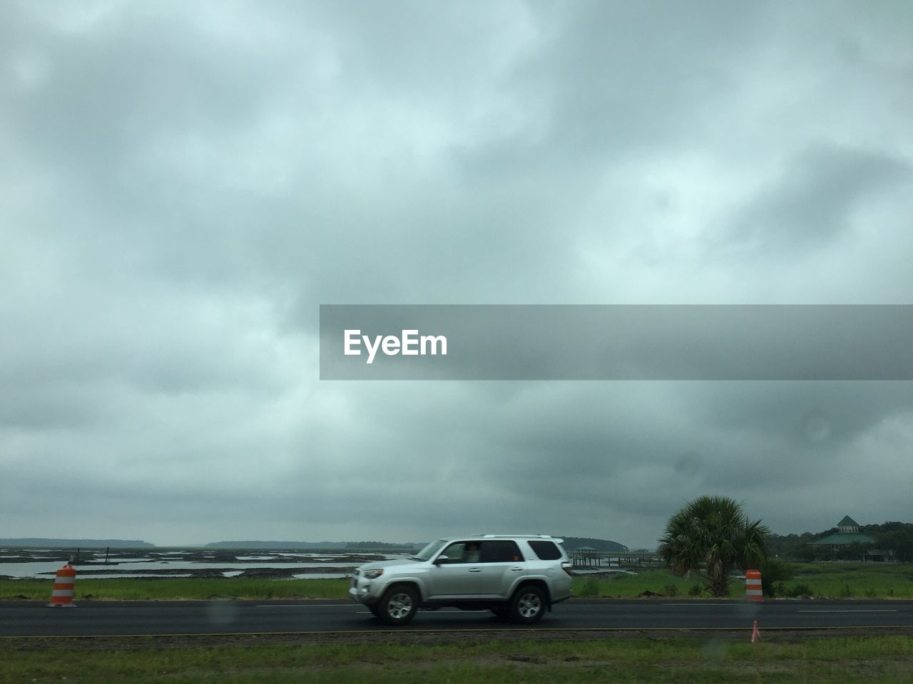 VIEW OF ROAD AGAINST CLOUDY SKY