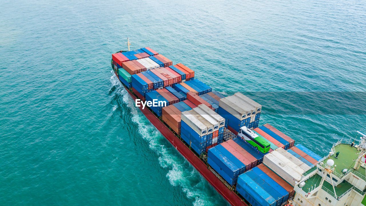 High angle view of cargo containers in ship sailing on sea