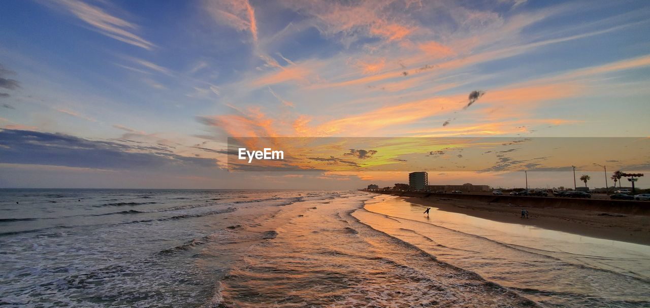 Scenic view of beach against sky during sunset