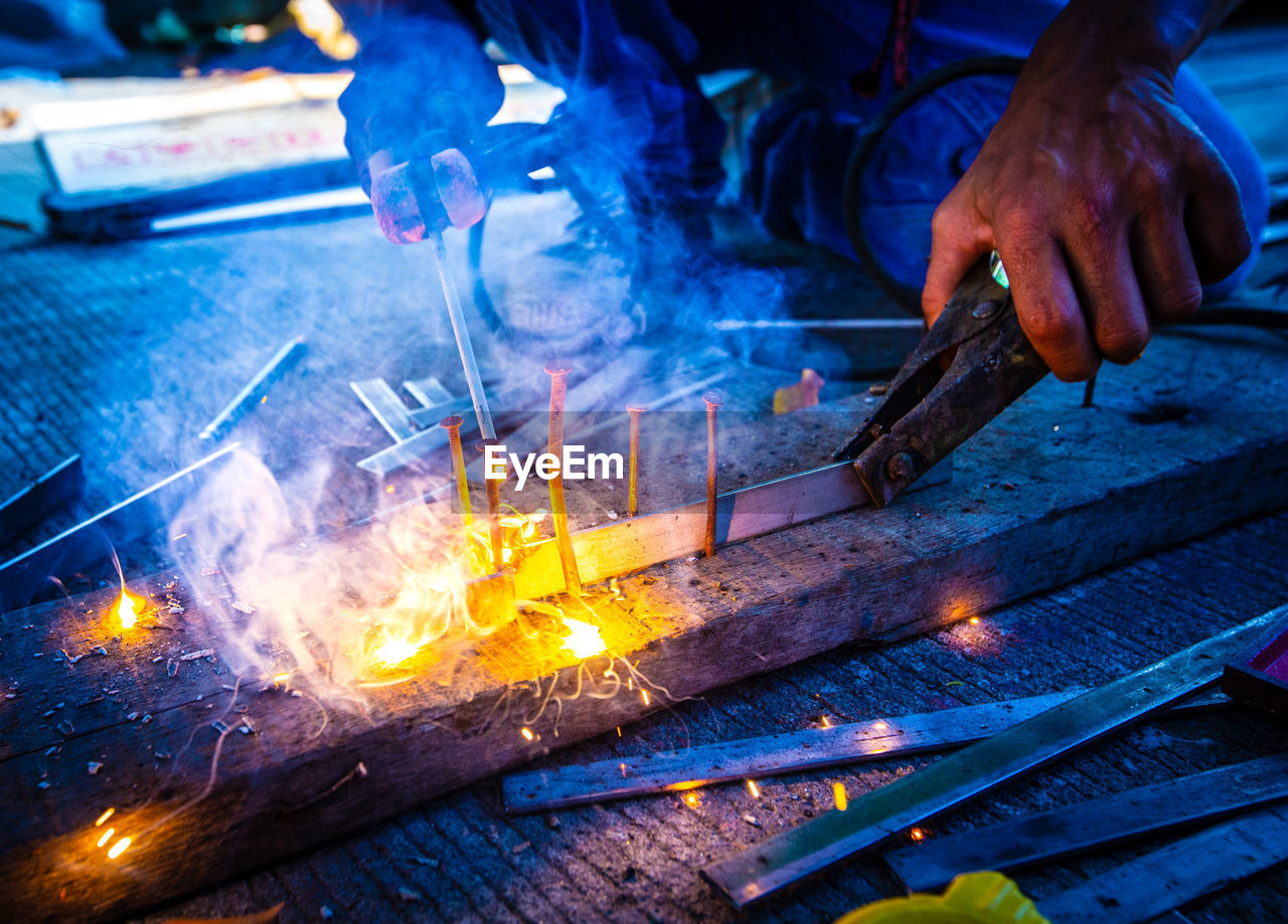 Welder at work in factory