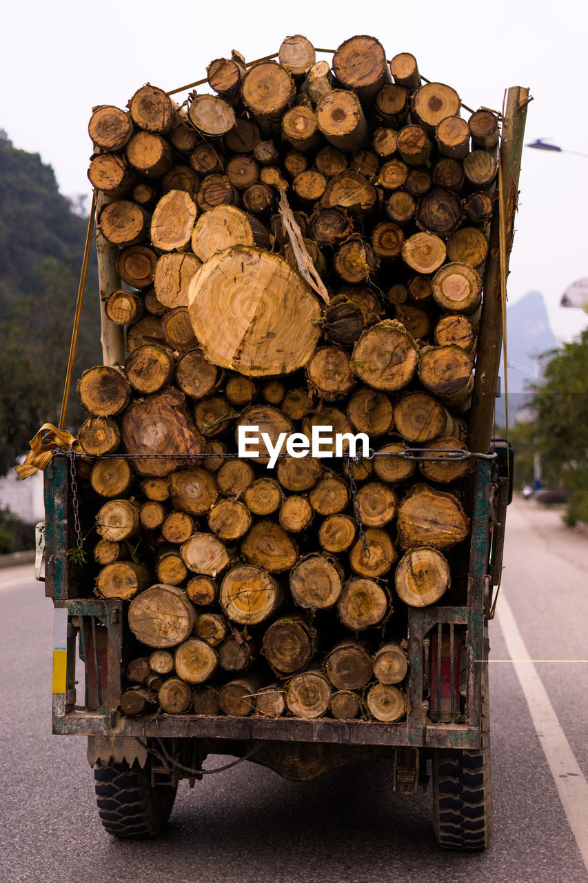 STACK OF LOGS AGAINST WALL