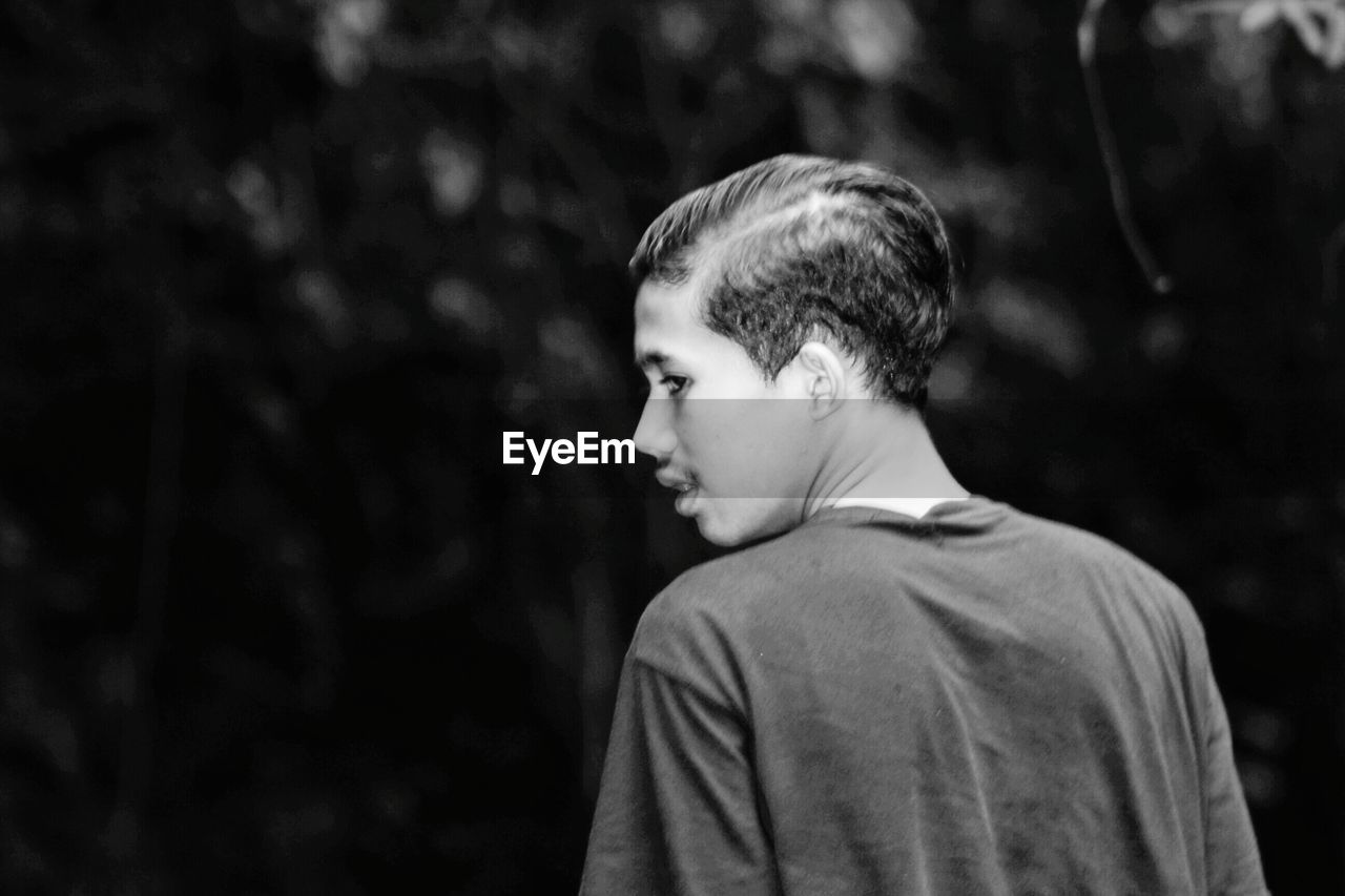 PORTRAIT OF BOY LOOKING AT FOREST