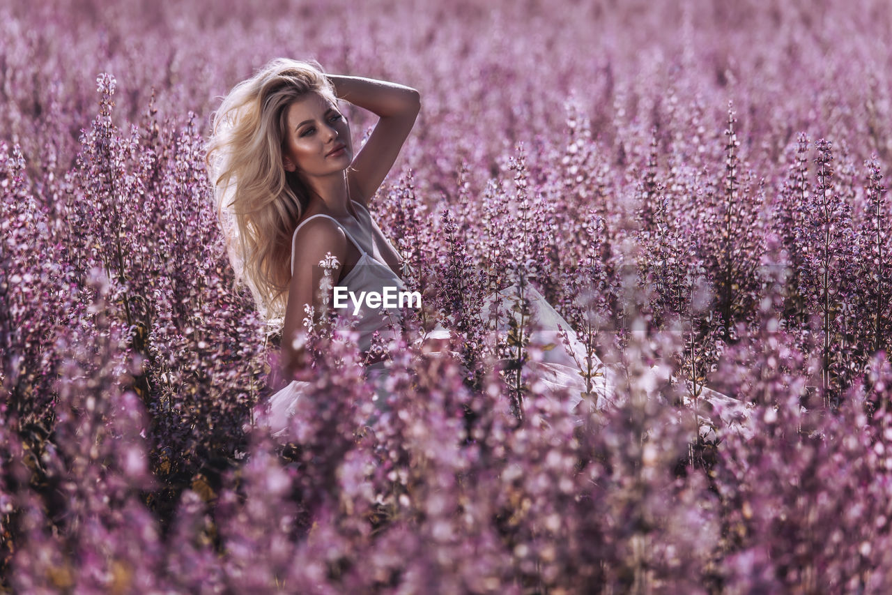 FULL LENGTH OF WOMAN WITH PINK FLOWERS ON FIELD