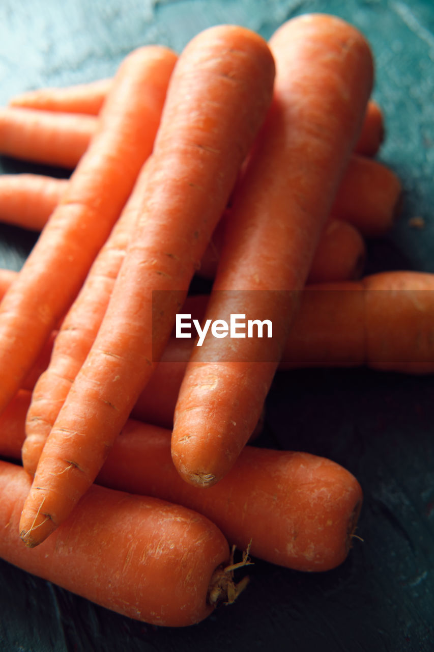 Several orange carrots on a green background