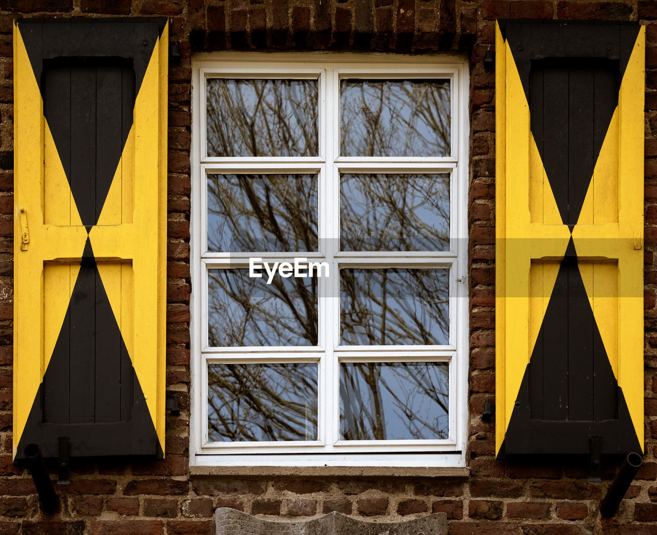 Close-up of yellow window on building