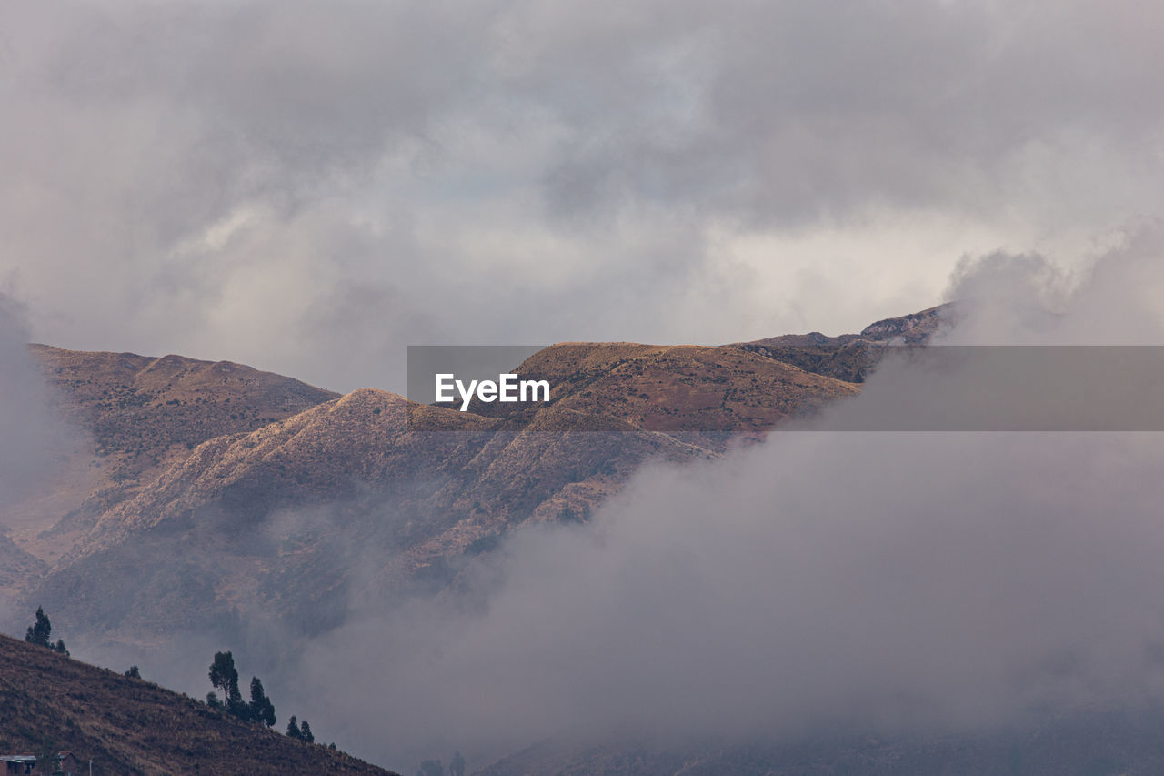 Scenic view of mountains against cloudy sky