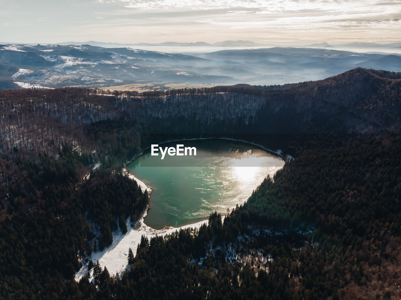 High angle view of sea and mountains against sky