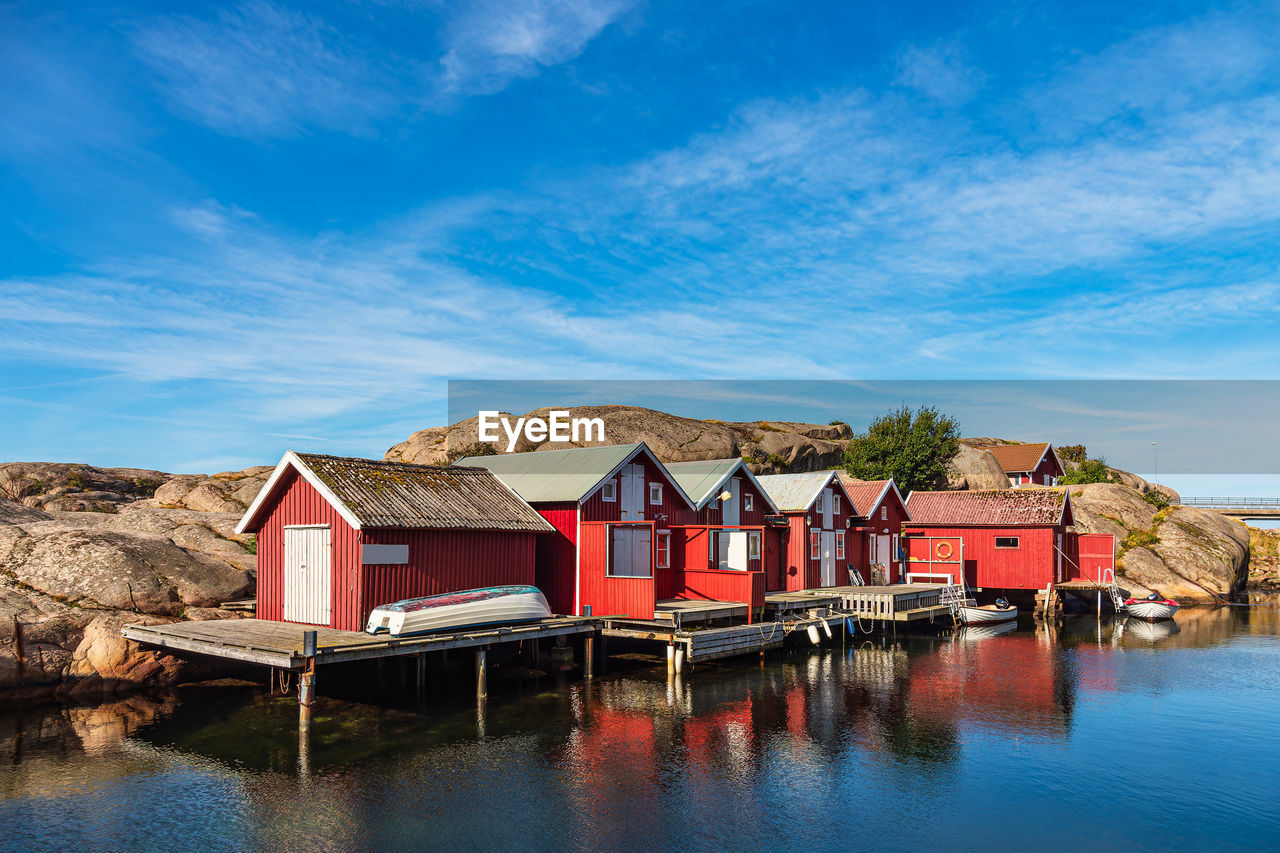 houses by river against sky