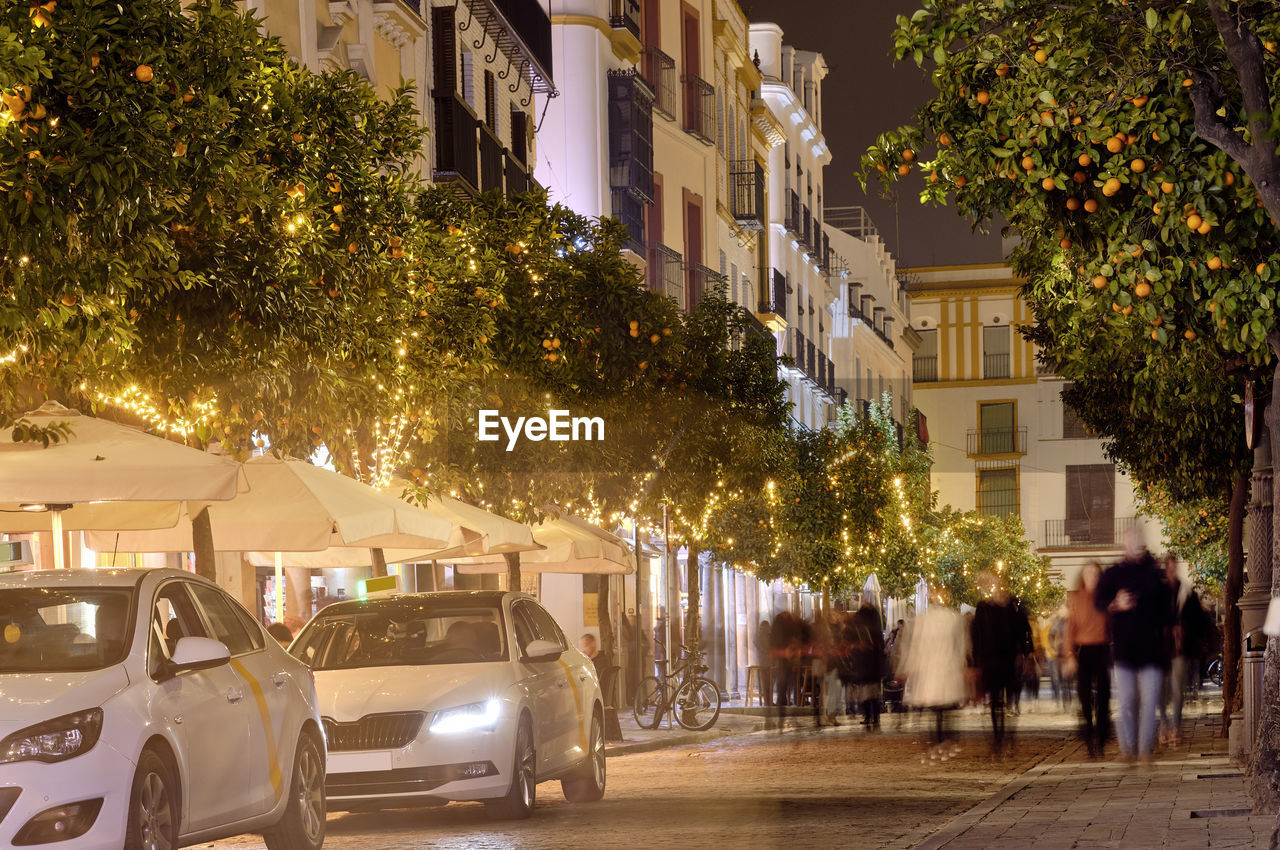 CARS ON STREET BY BUILDINGS IN CITY