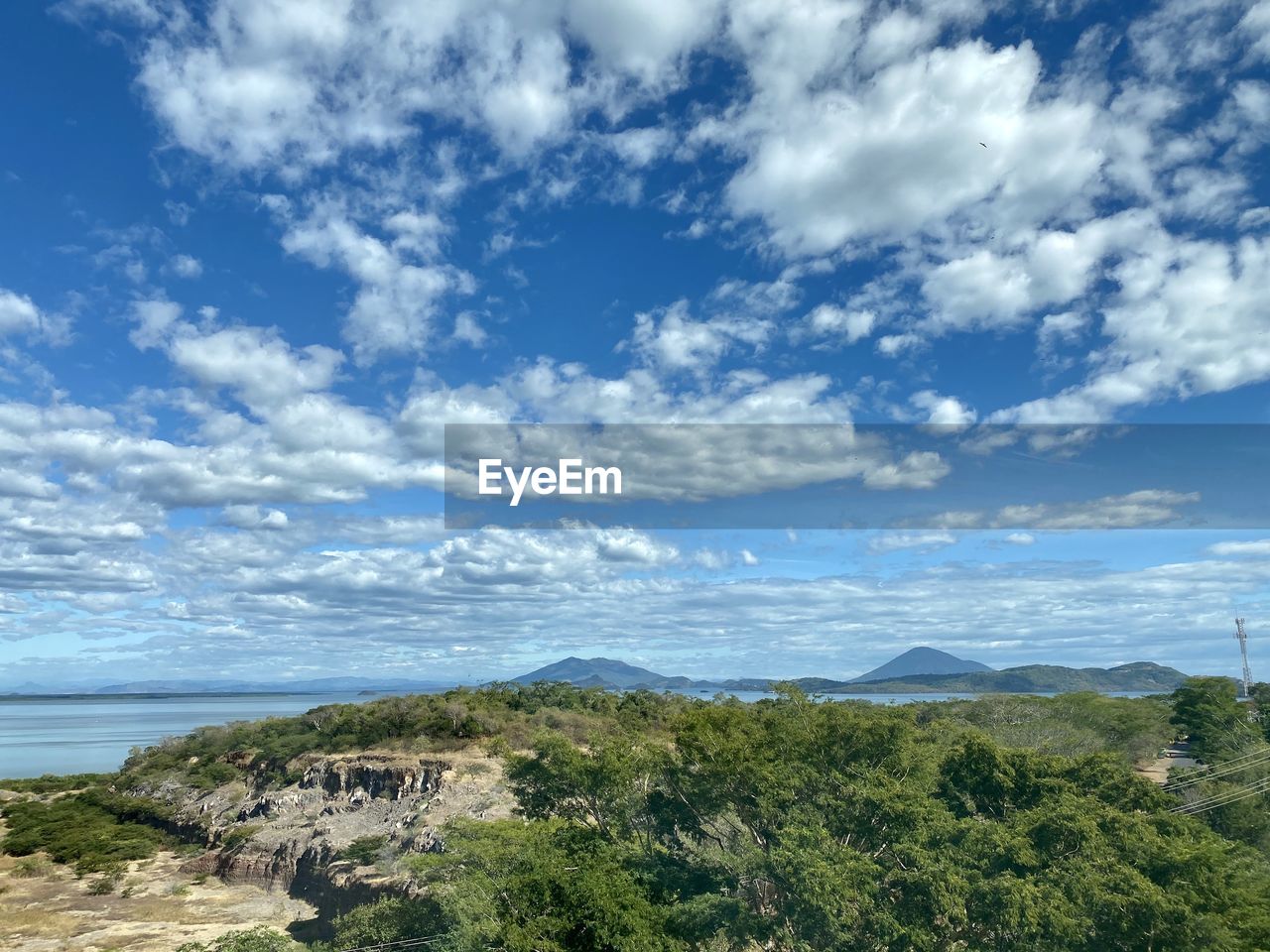 Scenic view of sea and mountains against sky