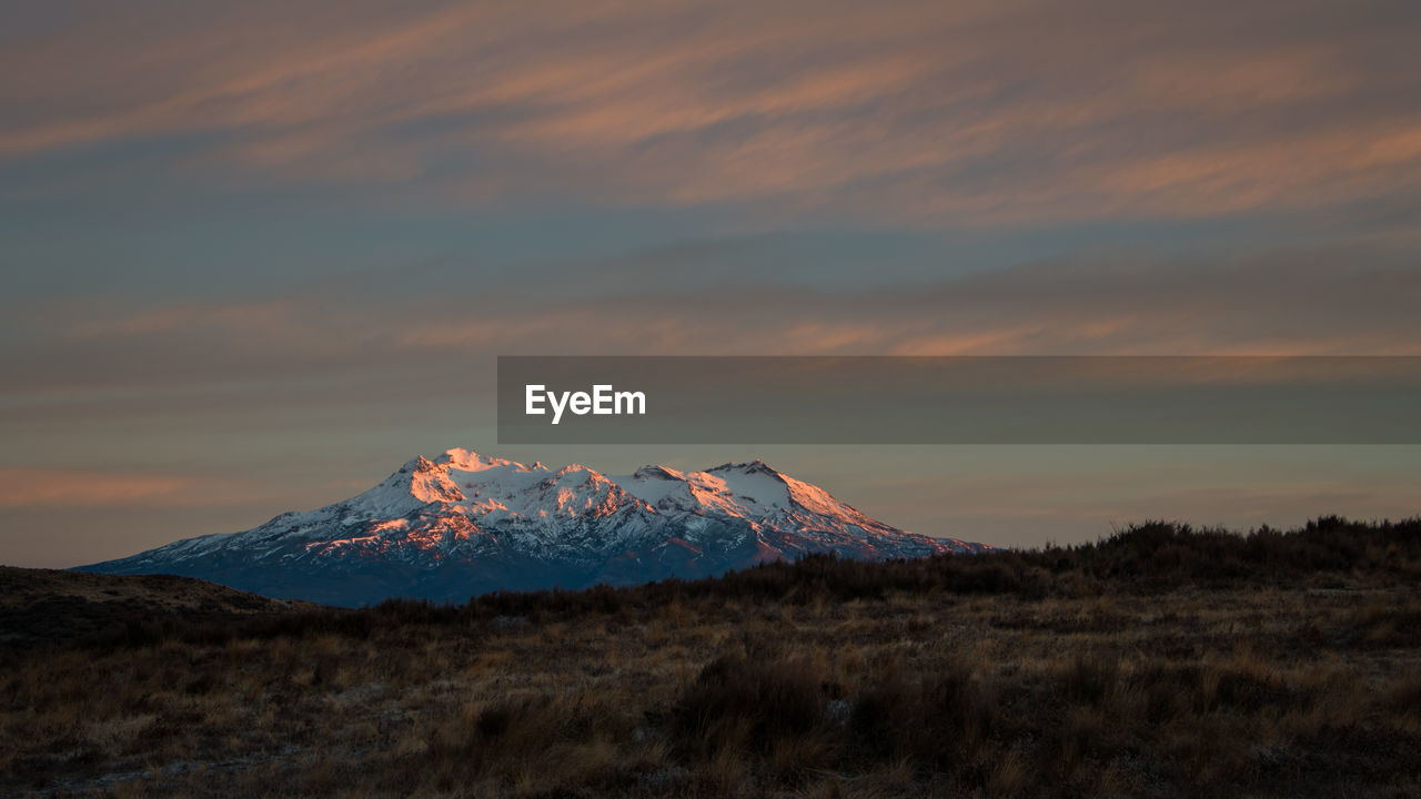 SCENIC VIEW OF VOLCANIC MOUNTAIN AGAINST SKY DURING SUNSET