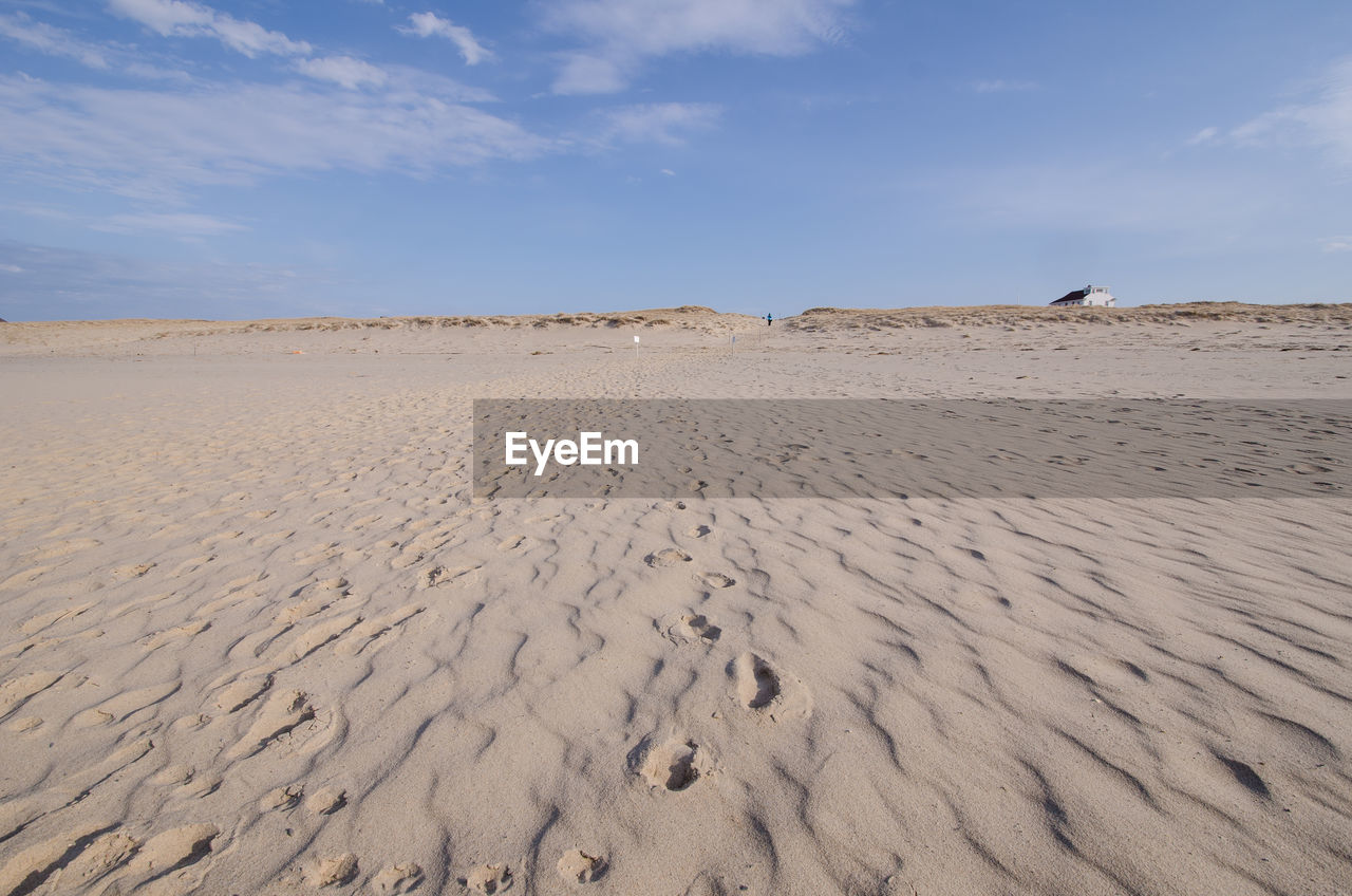 SAND DUNES IN DESERT AGAINST SKY