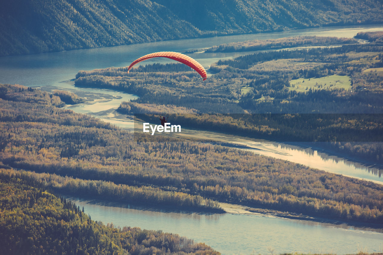 High angle view of hot air balloon flying over landscape