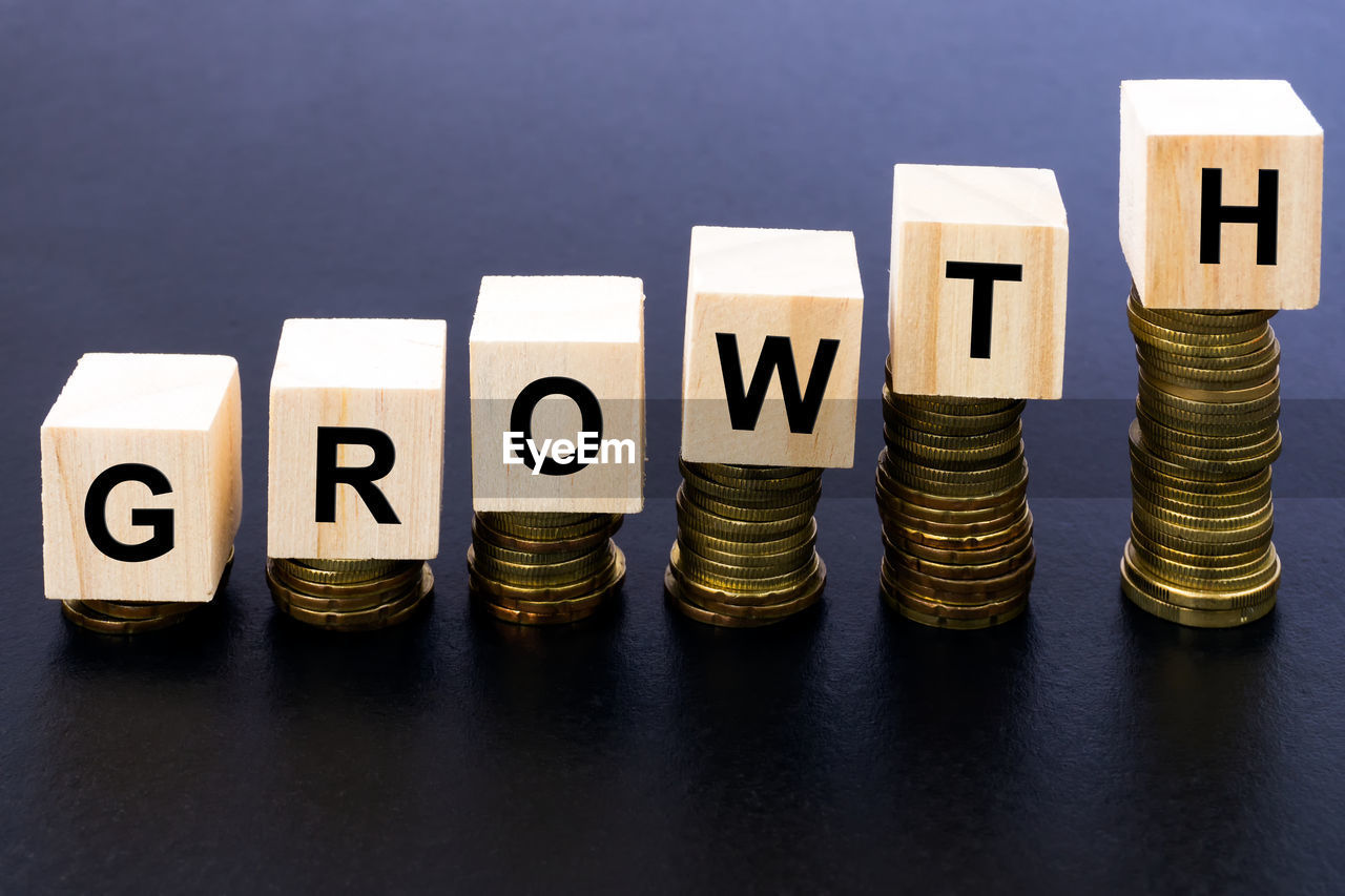 Stack of coins with growth text on table