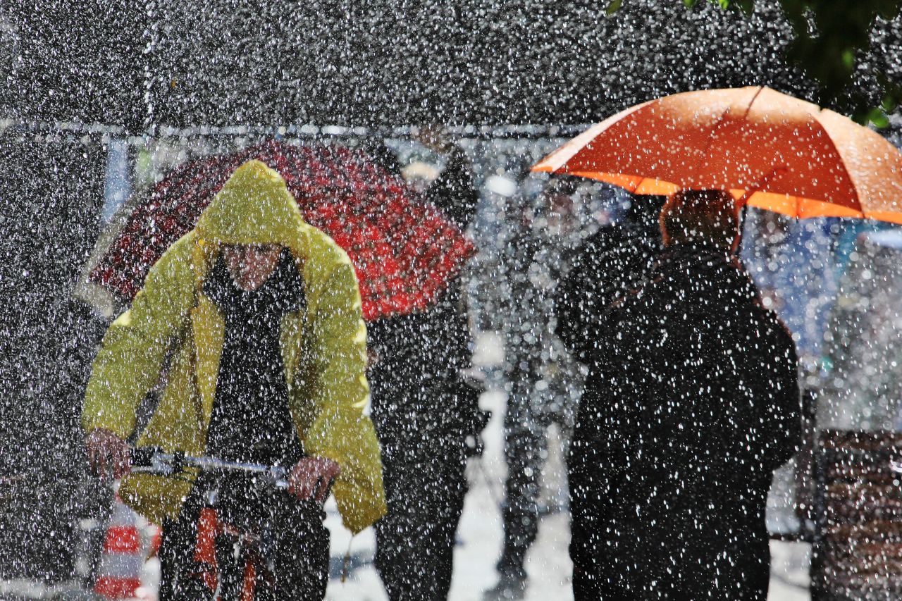 People walking on street during snowing