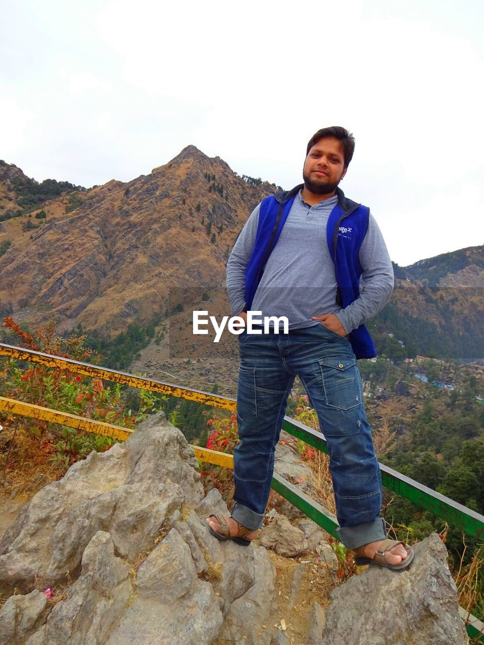 Portrait of man standing on rock at observation point