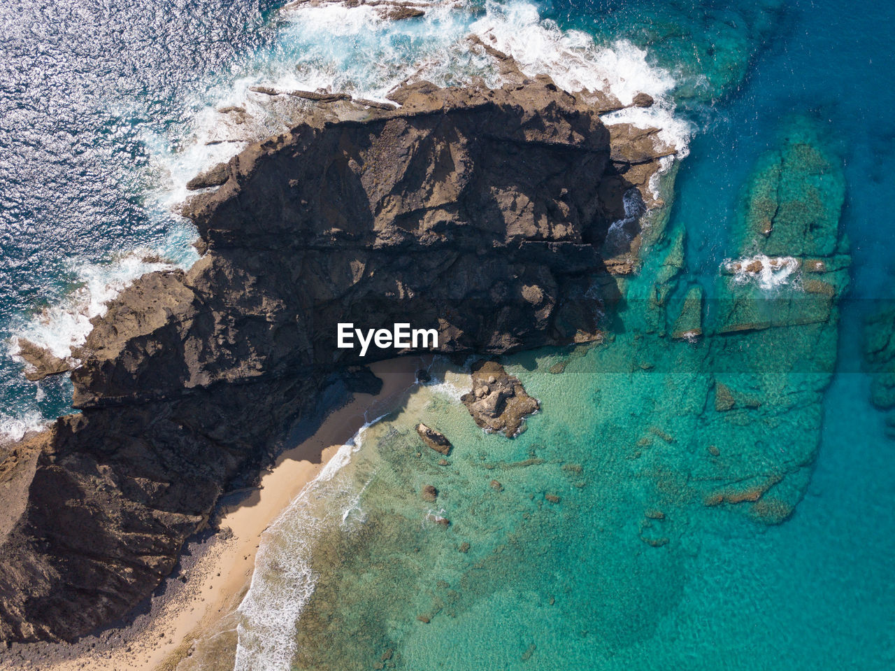 High angle view of rock and sea