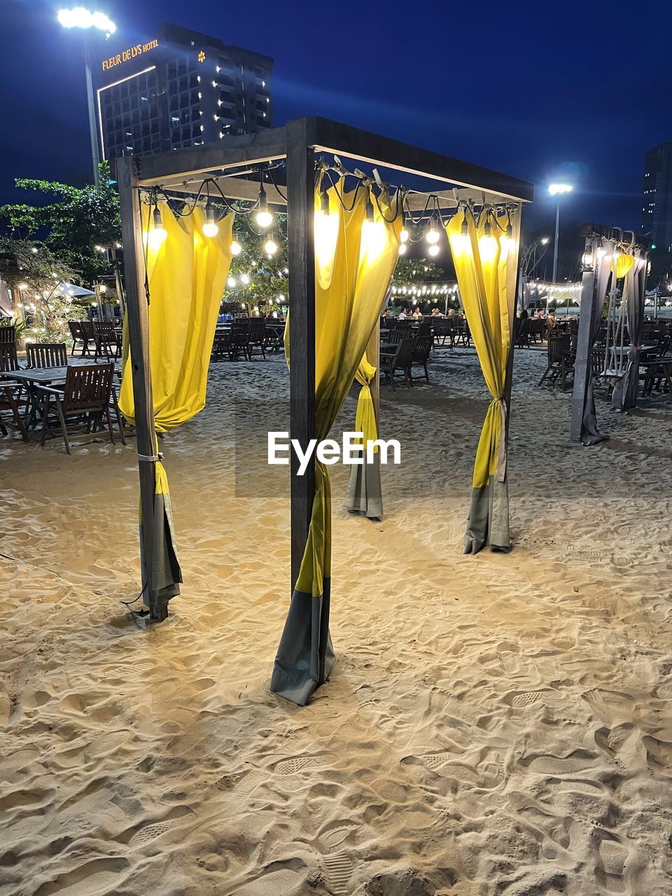 ILLUMINATED YELLOW LIGHTS ON SANDY BEACH