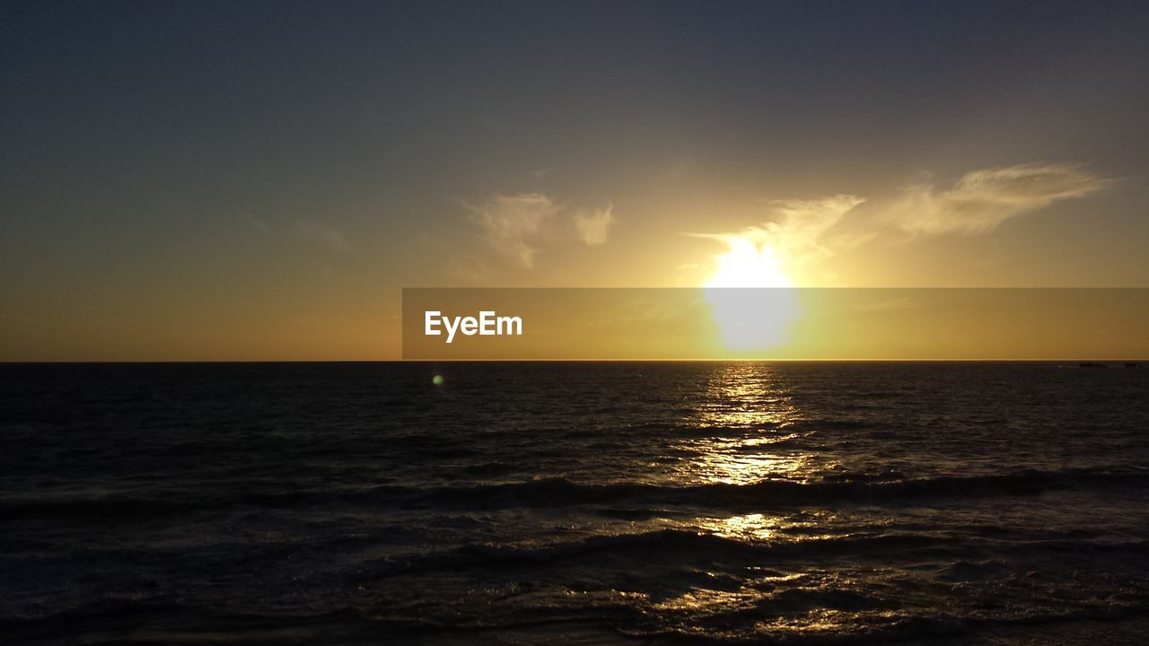 Scenic view of sea against sky at sunset