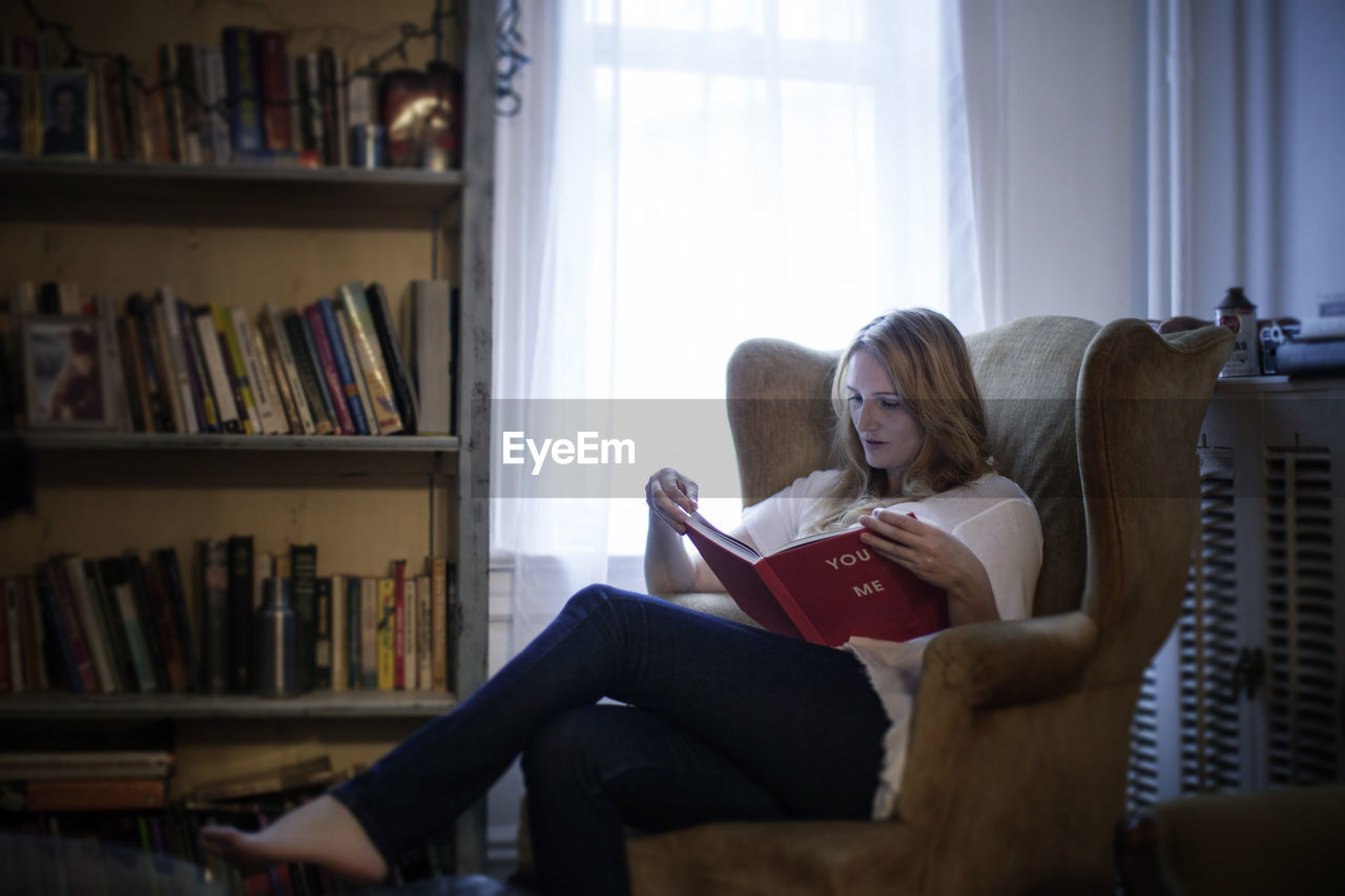 Woman reading book at home