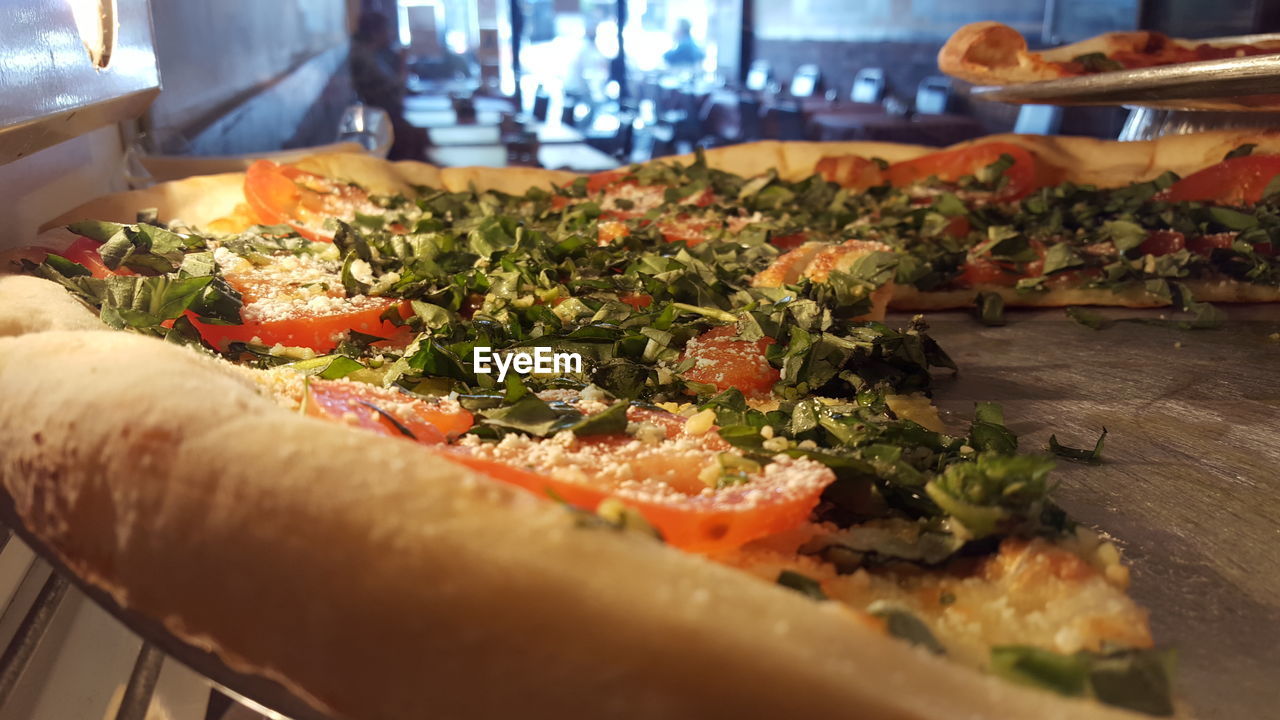 Close-up of served veg pizza in restaurant 