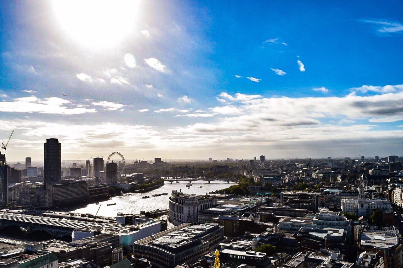 View of cityscape against cloudy sky